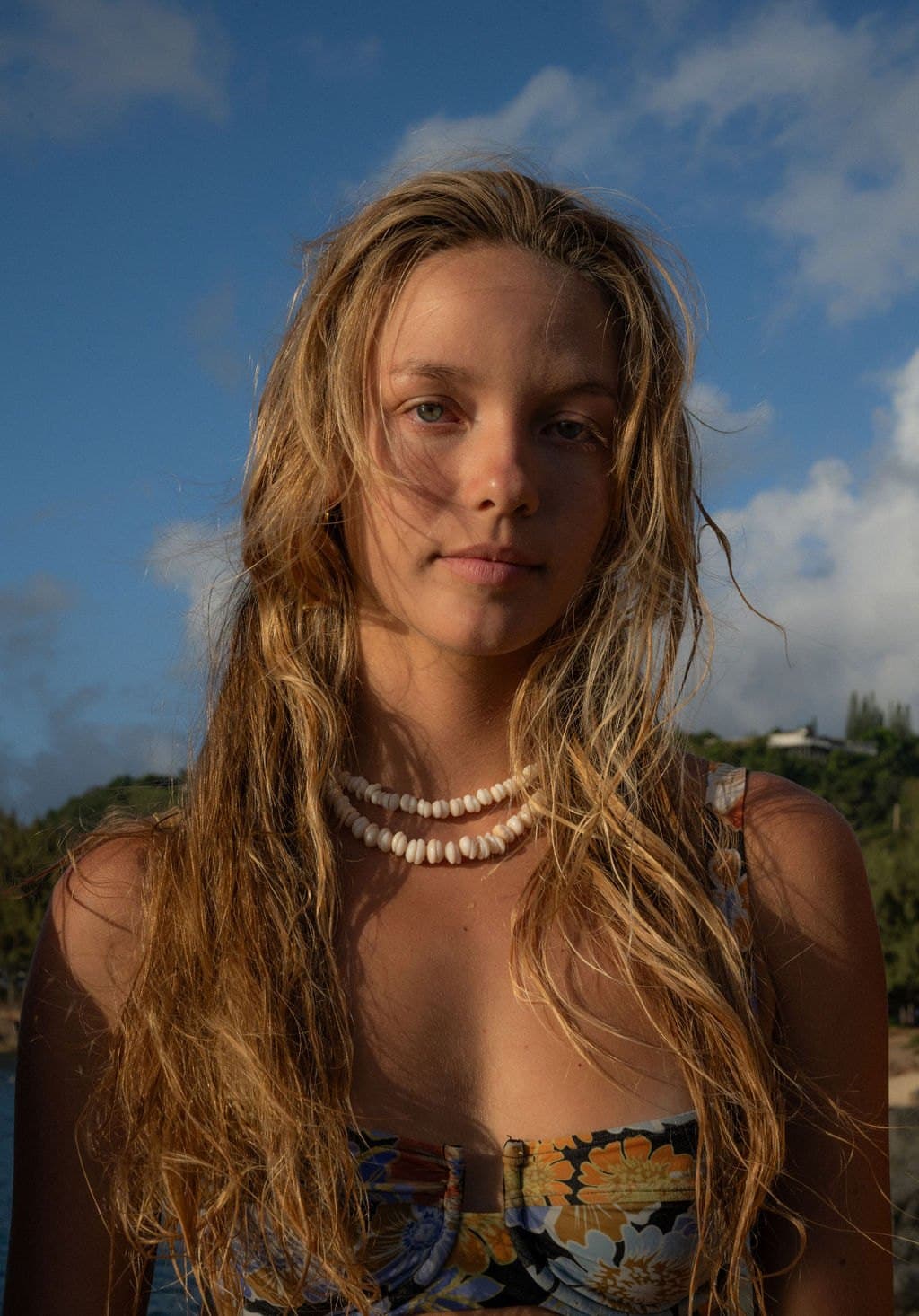 Portrait of a model with wet hair and a shell necklace
