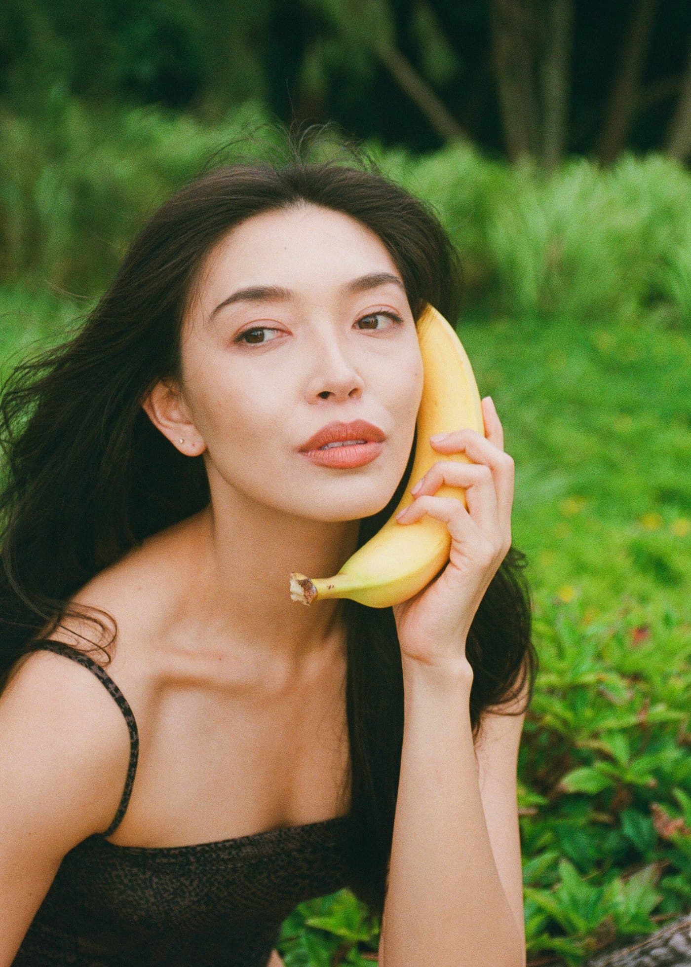 Model holding a banana to her ear like a phone